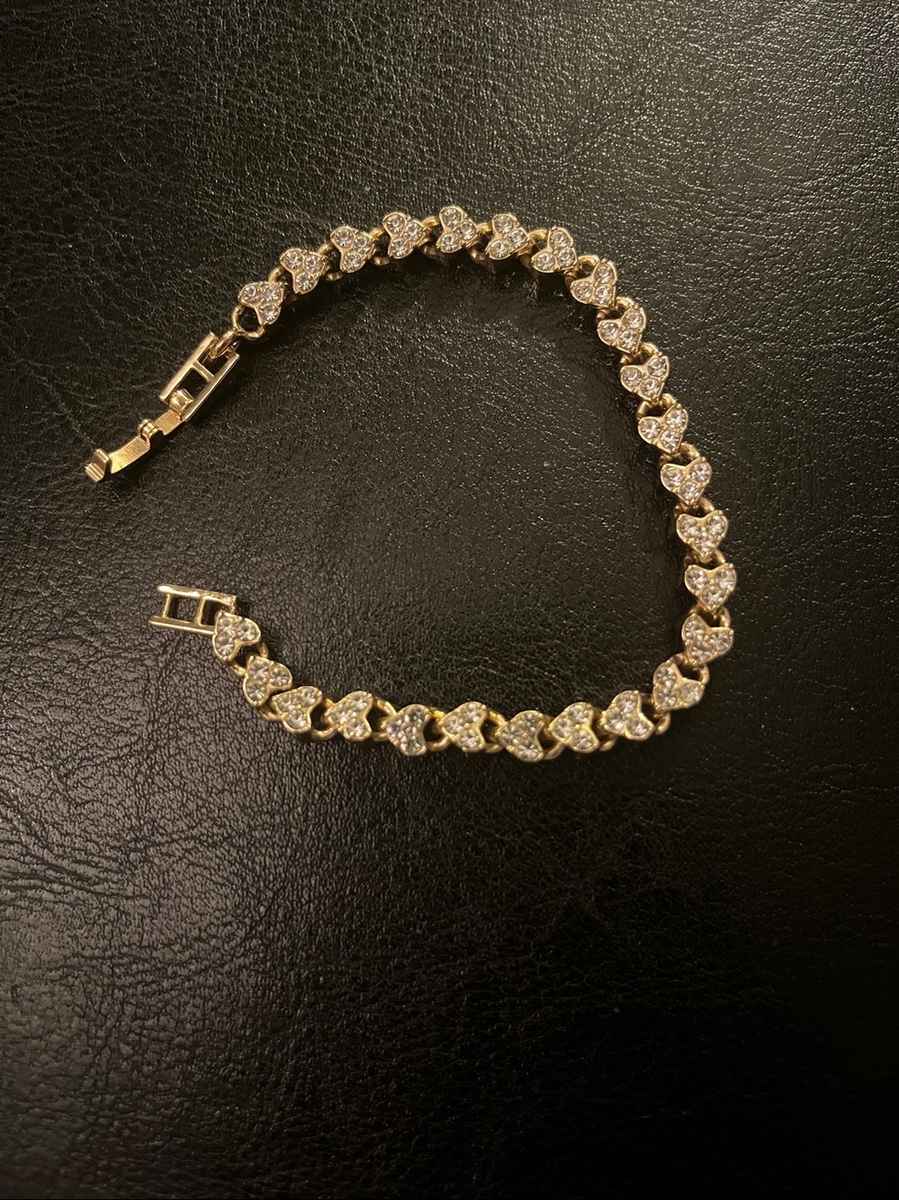 Gold rhinestone hearts bracelet.